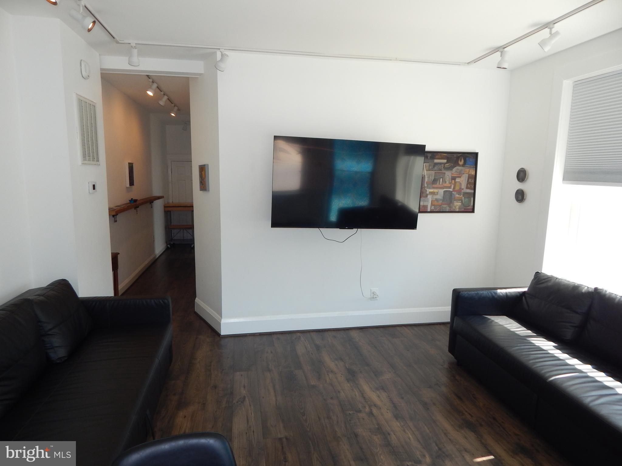 1002 Fawn Street Baltimore, MD 21202 - Photo 8 of 27 a living room with furniture and a flat screen tv
