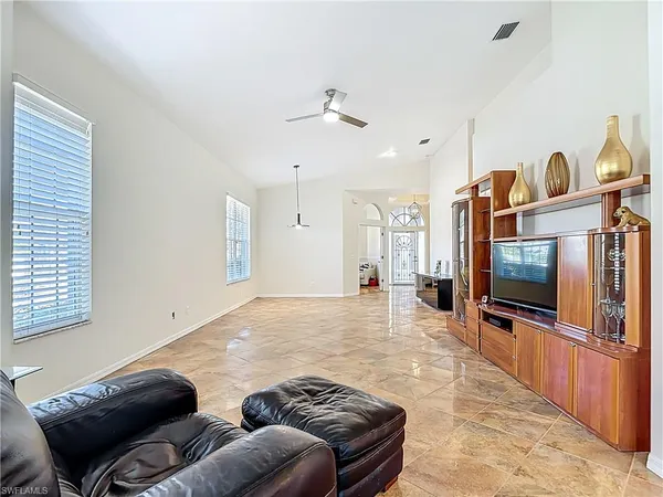 a living room with furniture and a flat screen tv