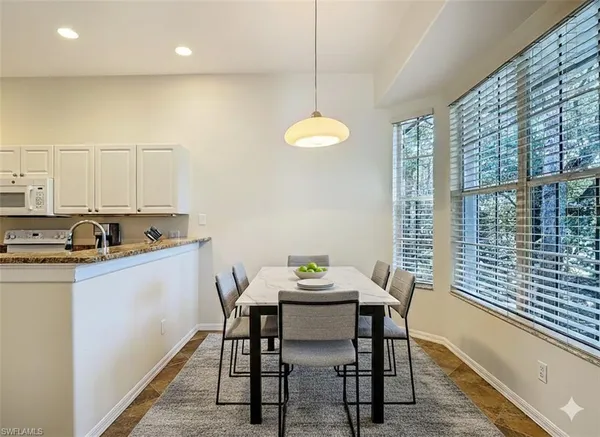 a kitchen that has a table and chairs in it
