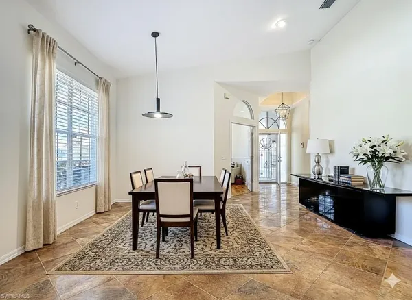 a dining room with furniture and window