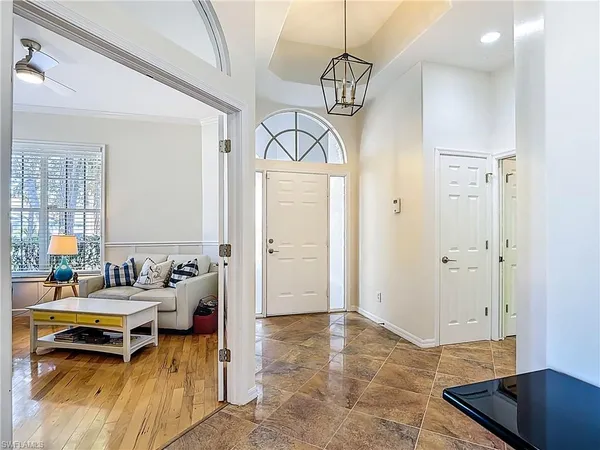 a living room with furniture and a chandelier
