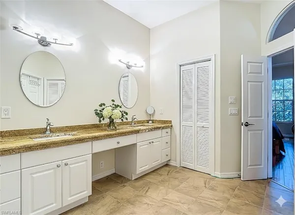 a bathroom with a double vanity sink and a mirror