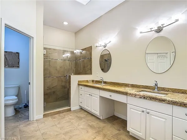 a bathroom with a toilet a sink and a mirror