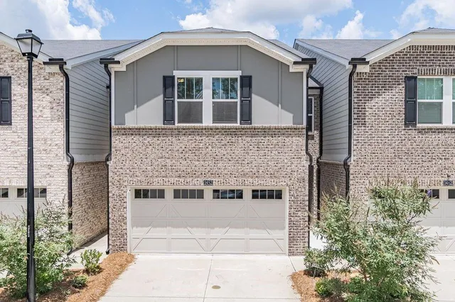 a front view of a house with a garage
