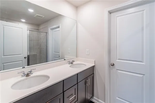 a bathroom with a double vanity sink and a mirror