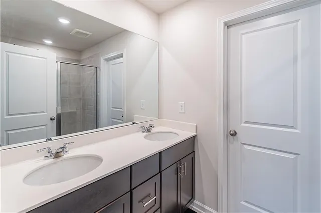 a bathroom with a double vanity sink and a mirror