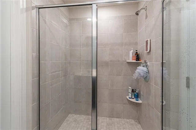 a bathroom with a glass shower door