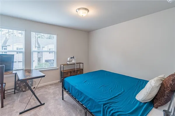 a bedroom with a bed and a table in it