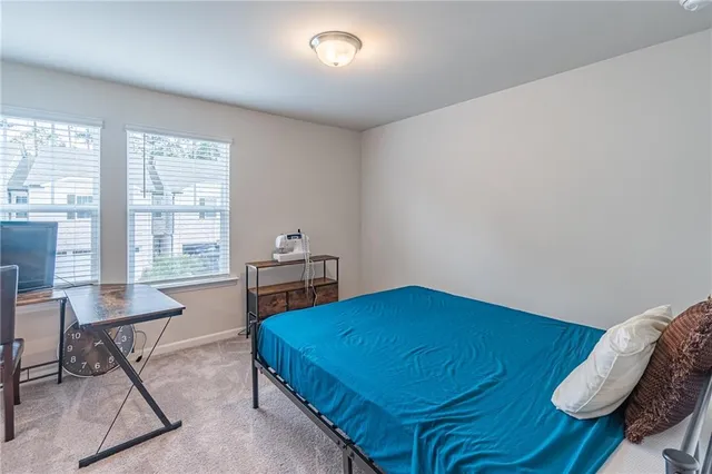 a bedroom with a bed and a table in it