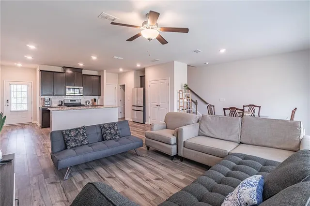 a living room with furniture and kitchen view