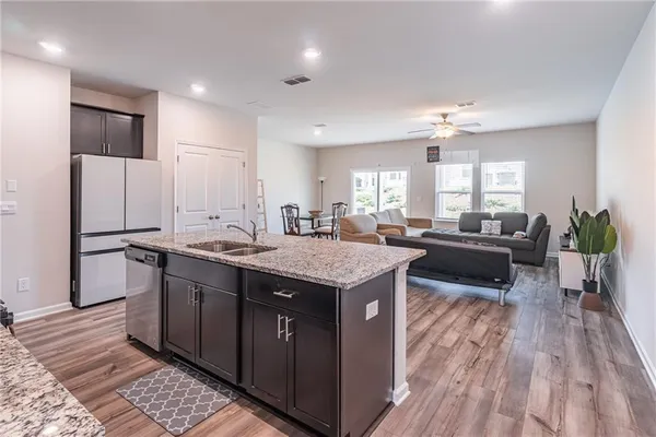 a kitchen with stainless steel appliances granite countertop a sink stove and refrigerator