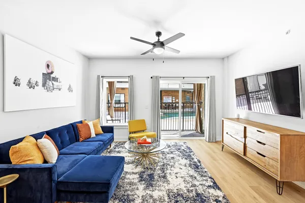 a living room with furniture and a flat screen tv