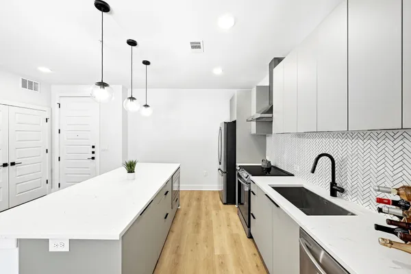 a kitchen with a sink a stove and refrigerator