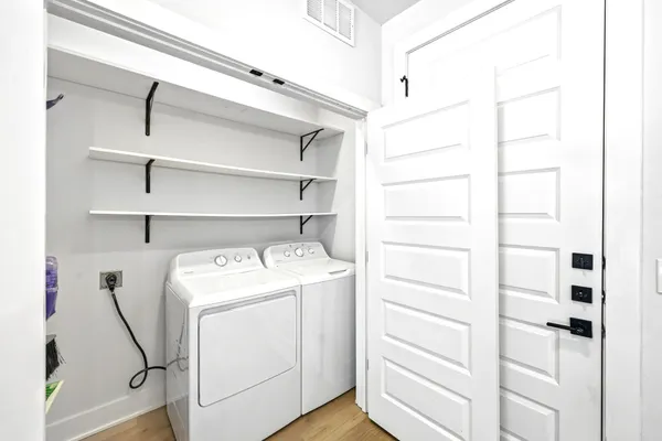 a view of storage and utility room with washer and dryer