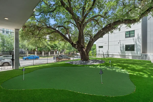 a swimming pool with outdoor seating and a garden