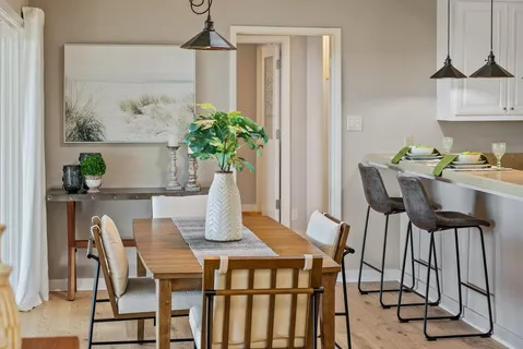 a dining room with furniture and wooden floor