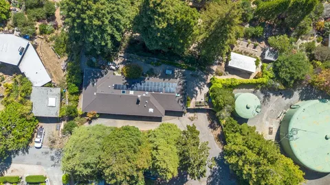 an aerial view of a house with outdoor space and pool view