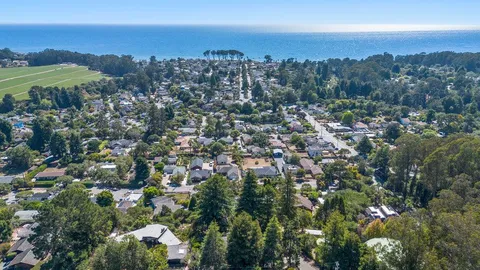 a bedroom with a large bed couch and a window
