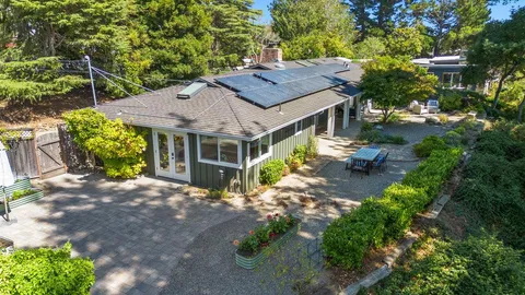 a view of a wooden house with a yard