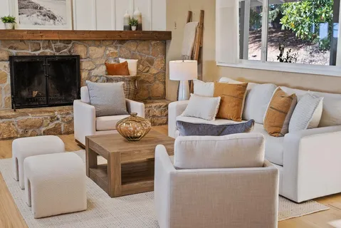 a living room with furniture and a fireplace