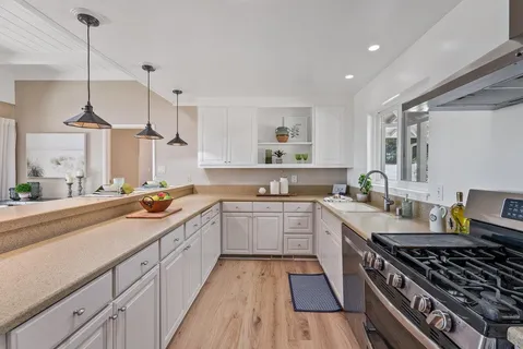 a kitchen with stainless steel appliances a stove sink and cabinets