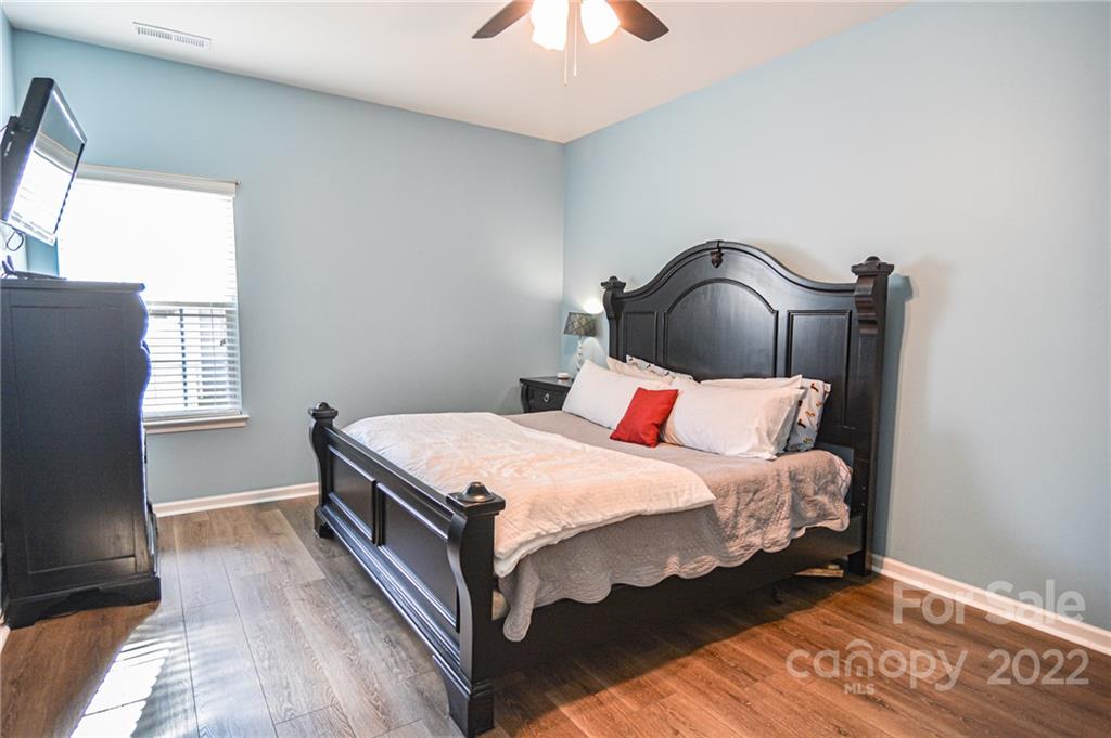 1617 Beleek Ridge Lane Clover, SC 29710 - Photo 17 of 22 a bedroom with a bed and a chandelier