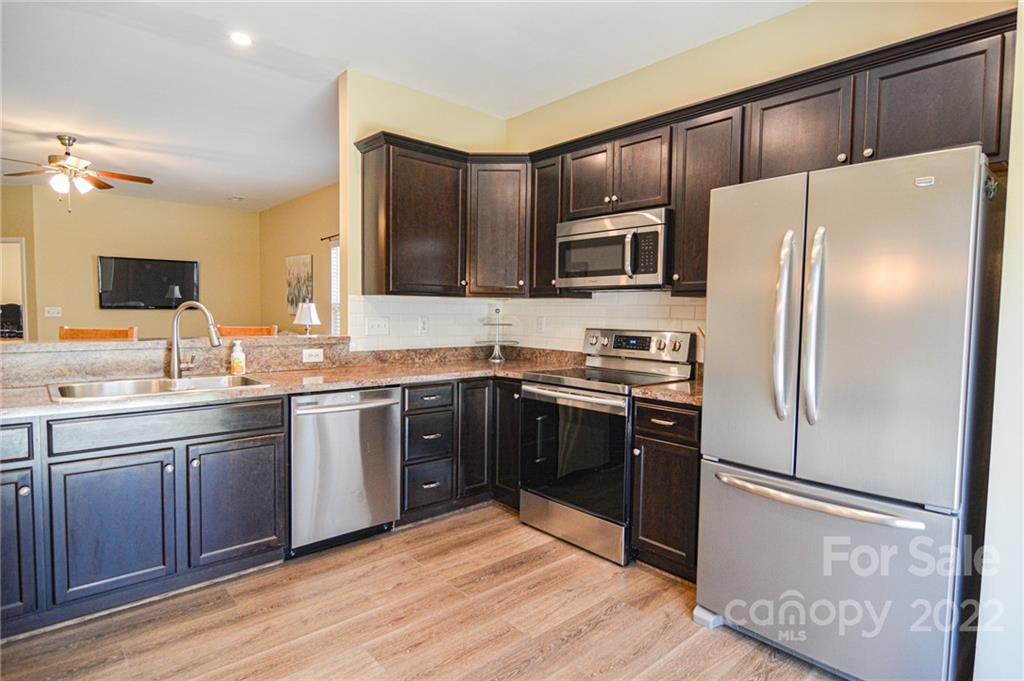 1617 Beleek Ridge Lane Clover, SC 29710 - Photo 10 of 22 a kitchen with granite countertop stainless steel appliances and wooden cabinets