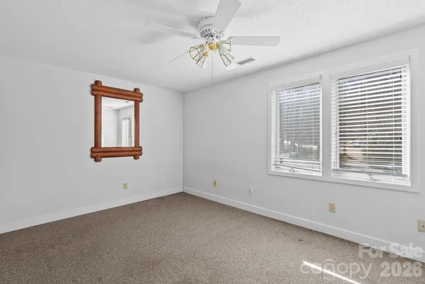 a bathroom with a granite countertop sink a toilet and a mirror