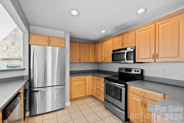 a kitchen with stainless steel appliances a refrigerator sink and microwave
