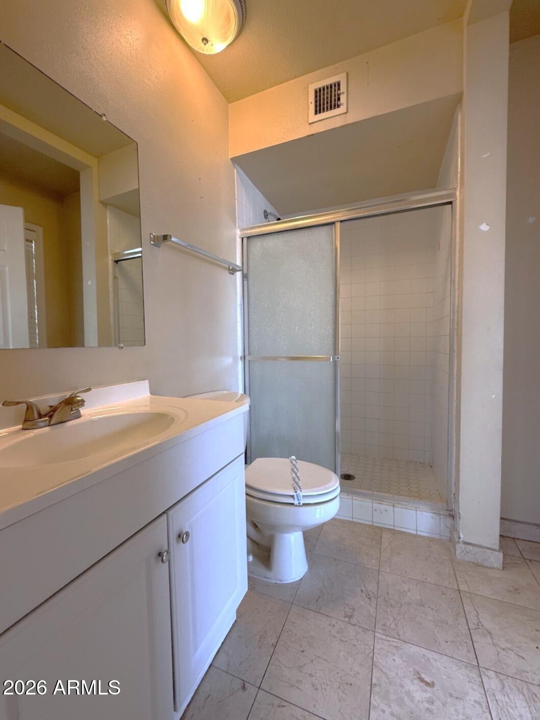4625 South Rita Lane Tempe, AZ 85282 - Photo 10 of 16 a bathroom with a granite countertop sink toilet and shower