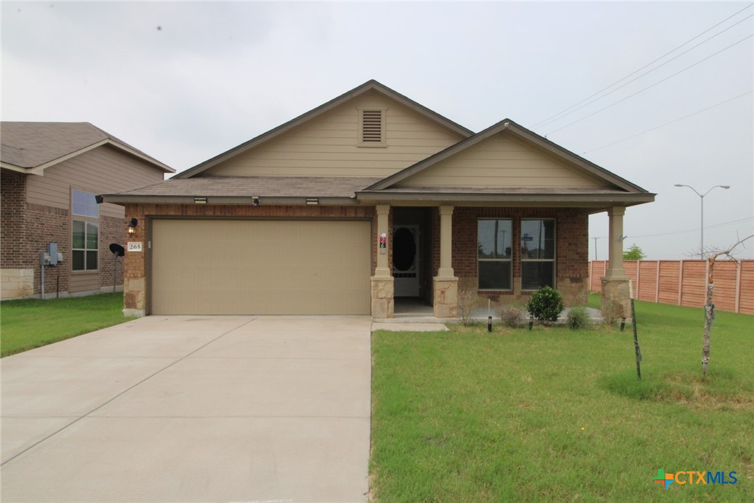 a front view of a house with a yard and porch