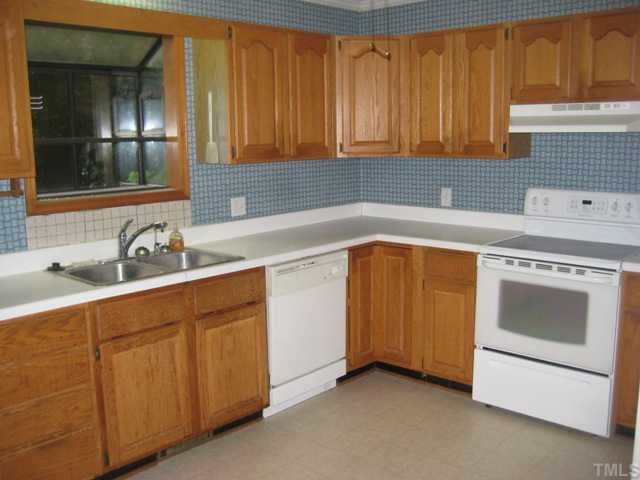 3914 Howard Circle Raleigh, NC 27604 - Photo 7 of 12 a kitchen with a sink stove and cabinets