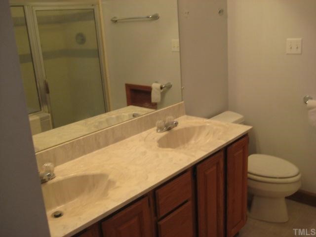 3914 Howard Circle Raleigh, NC 27604 - Photo 10 of 12 a bathroom with a sink toilet and vanity
