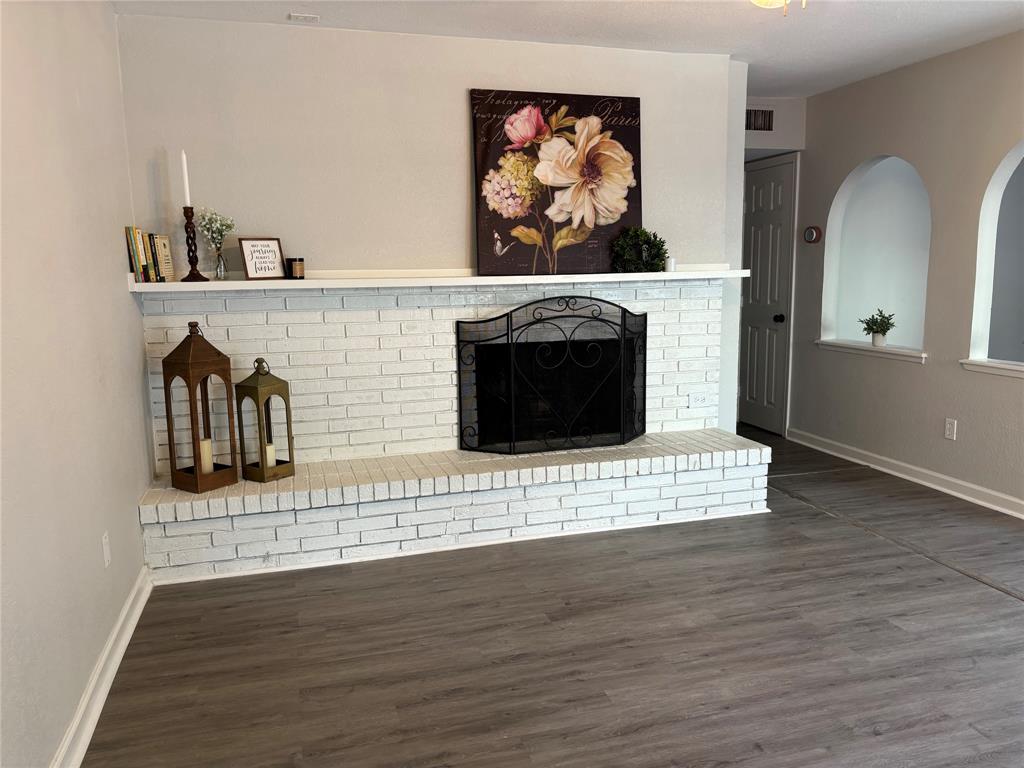 5036 Avery Lane The Colony, TX 75056 - Photo 11 of 22 a view of a fireplace with wooden floor