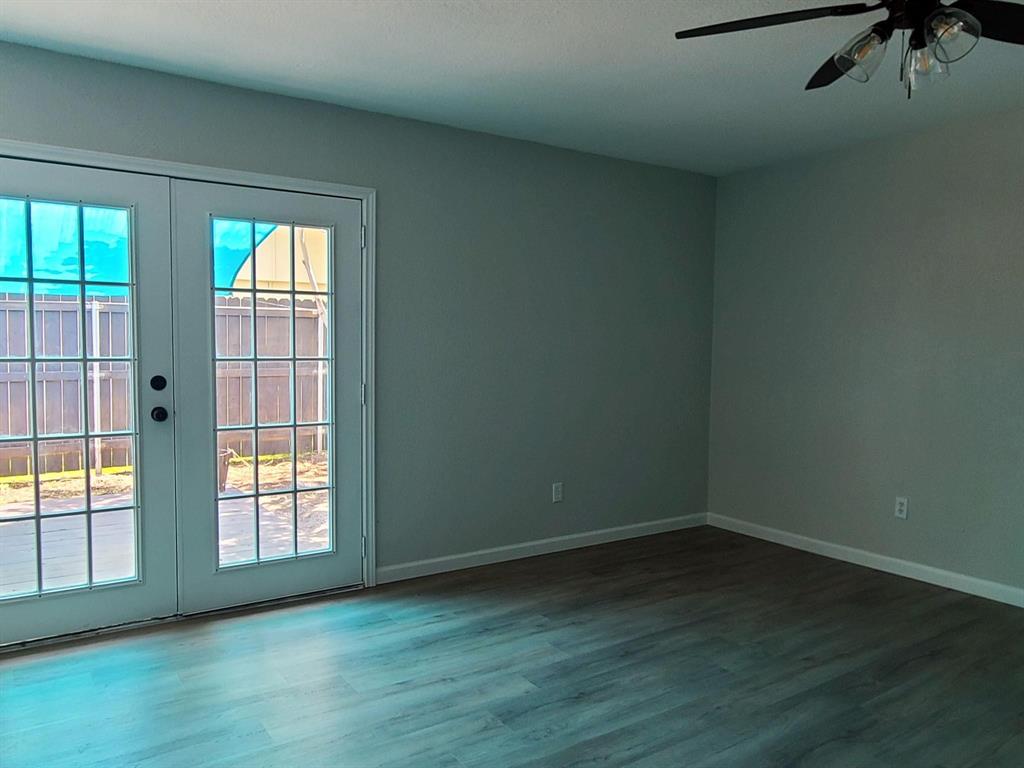 5036 Avery Lane The Colony, TX 75056 - Photo 12 of 22 an empty room with wooden floor and windows