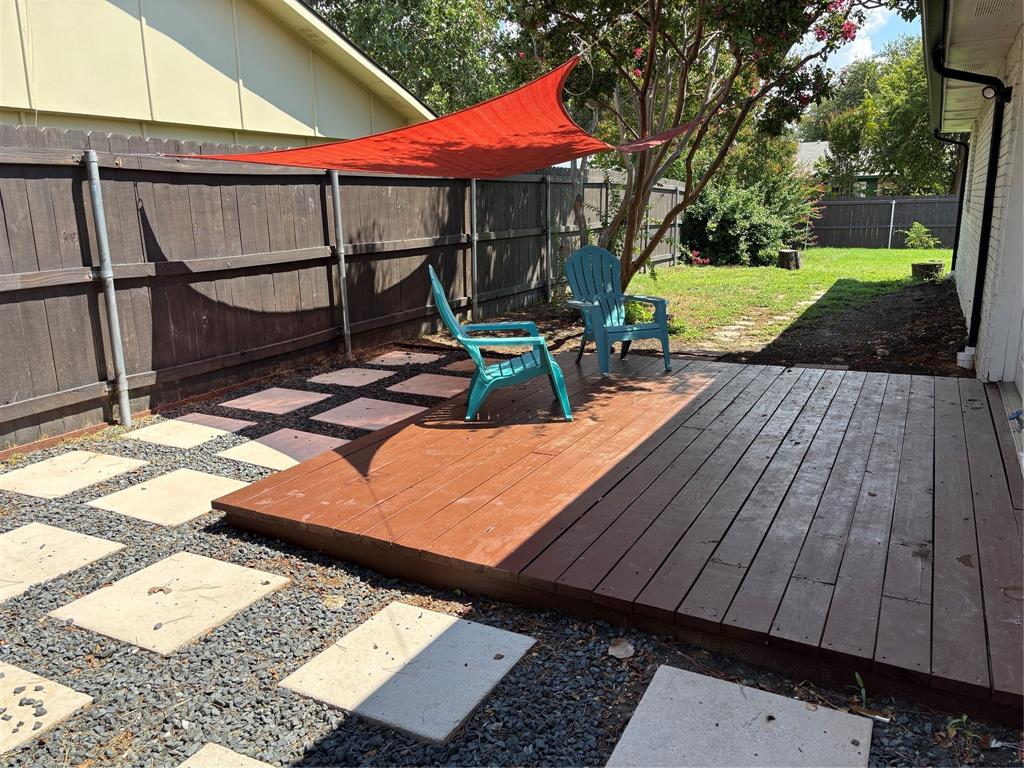 5036 Avery Lane The Colony, TX 75056 - Photo 21 of 22 a view of a patio with table and chairs under an umbrella with wooden floor