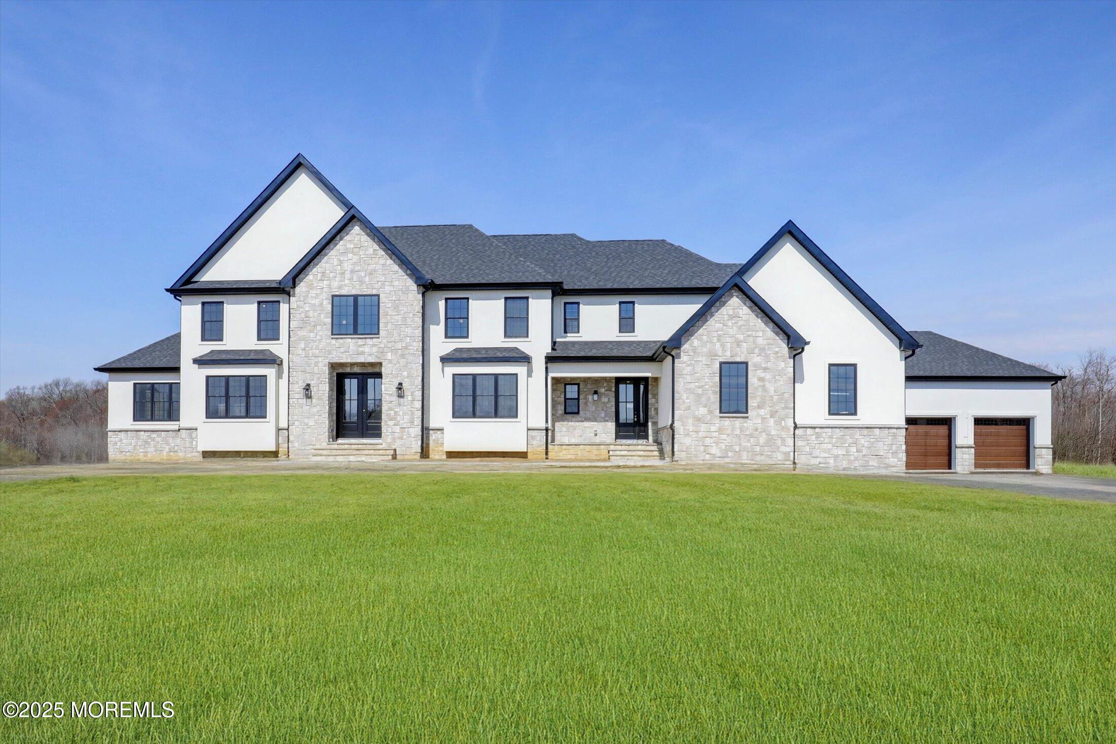 11 Cook Court Millstone Township, NJ 08535 - Photo 1 of 64 a front view of a house with a yard and trees