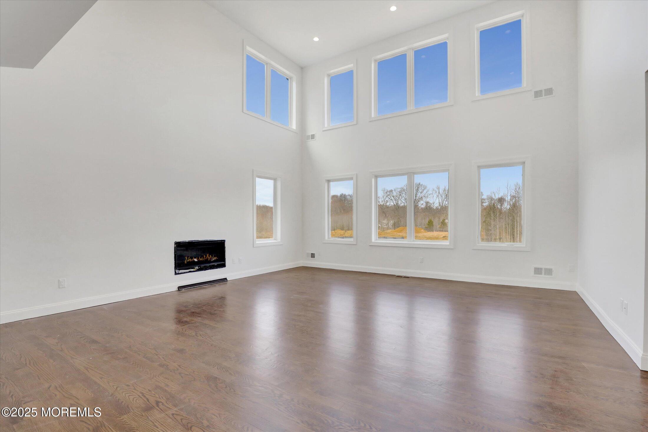 11 Cook Court Millstone Township, NJ 08535 - Photo 17 of 64 a view of an empty room with wooden floor and a window