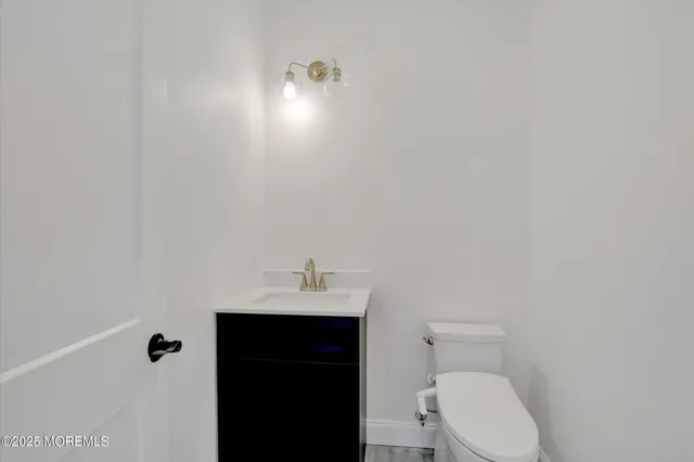 a bathroom with a sink a toilet and vanity