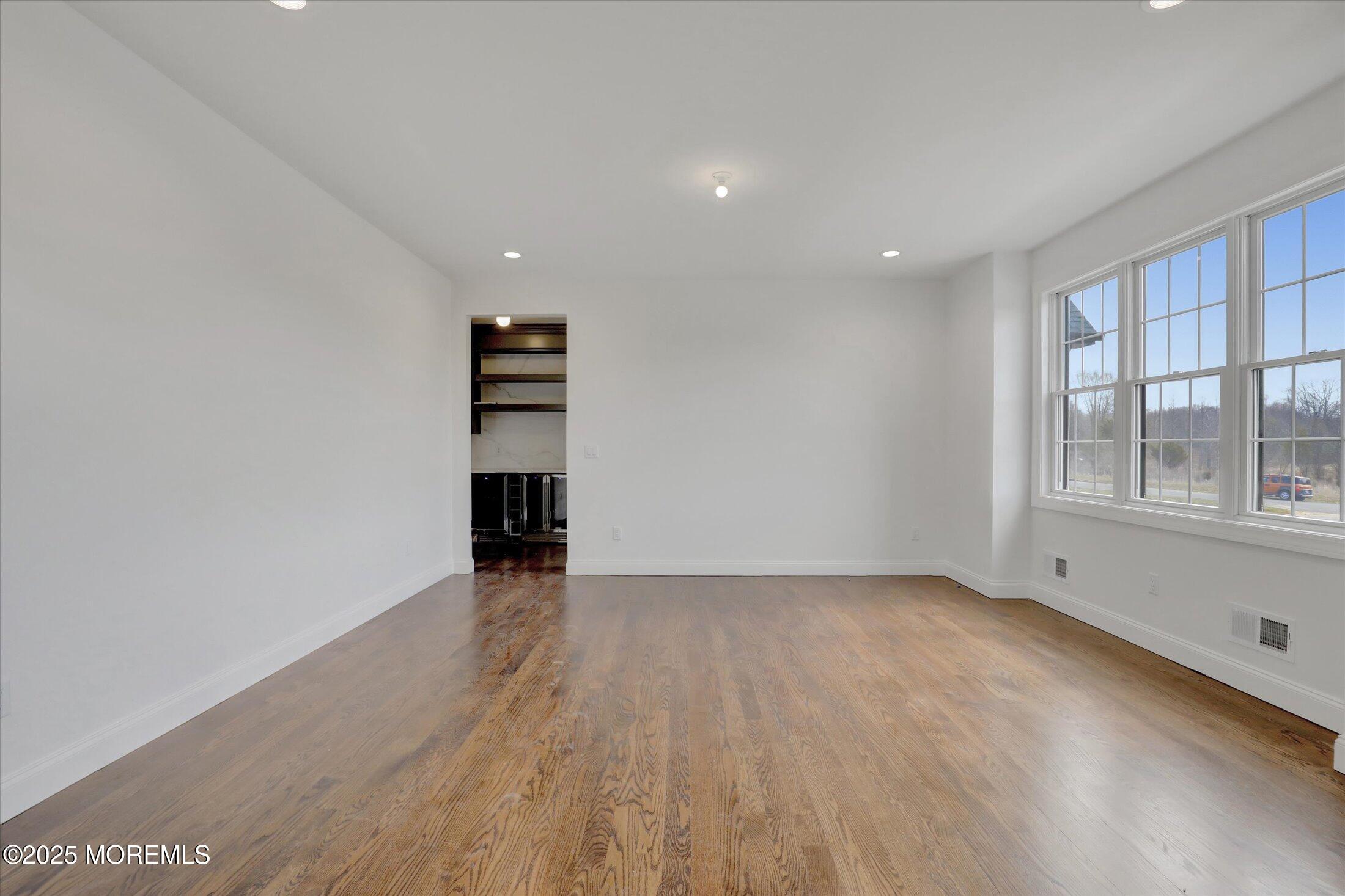 11 Cook Court Millstone Township, NJ 08535 - Photo 32 of 64 a view of an empty room with wooden floor and a window