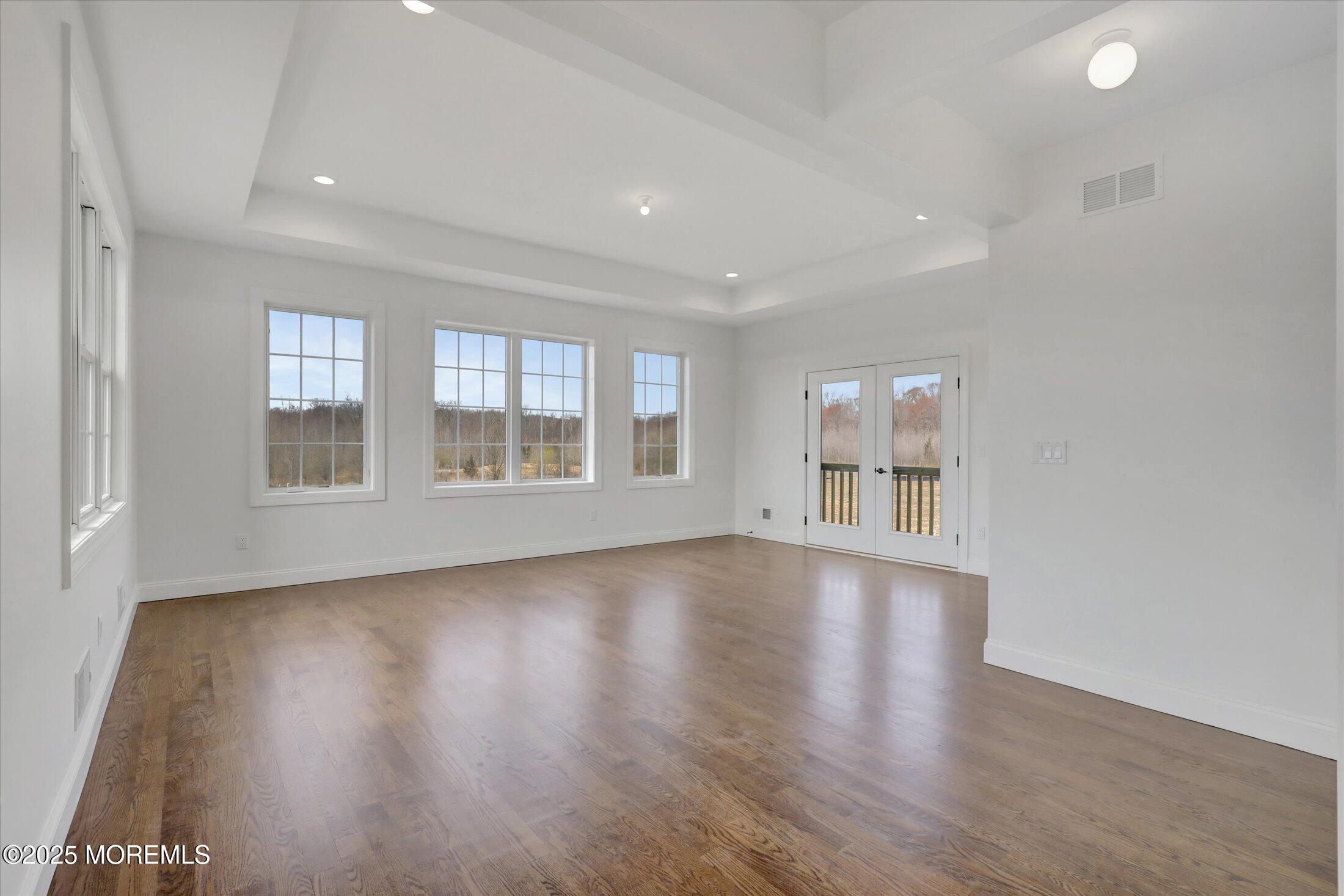 11 Cook Court Millstone Township, NJ 08535 - Photo 36 of 64 a view of an empty room with wooden floor and a window