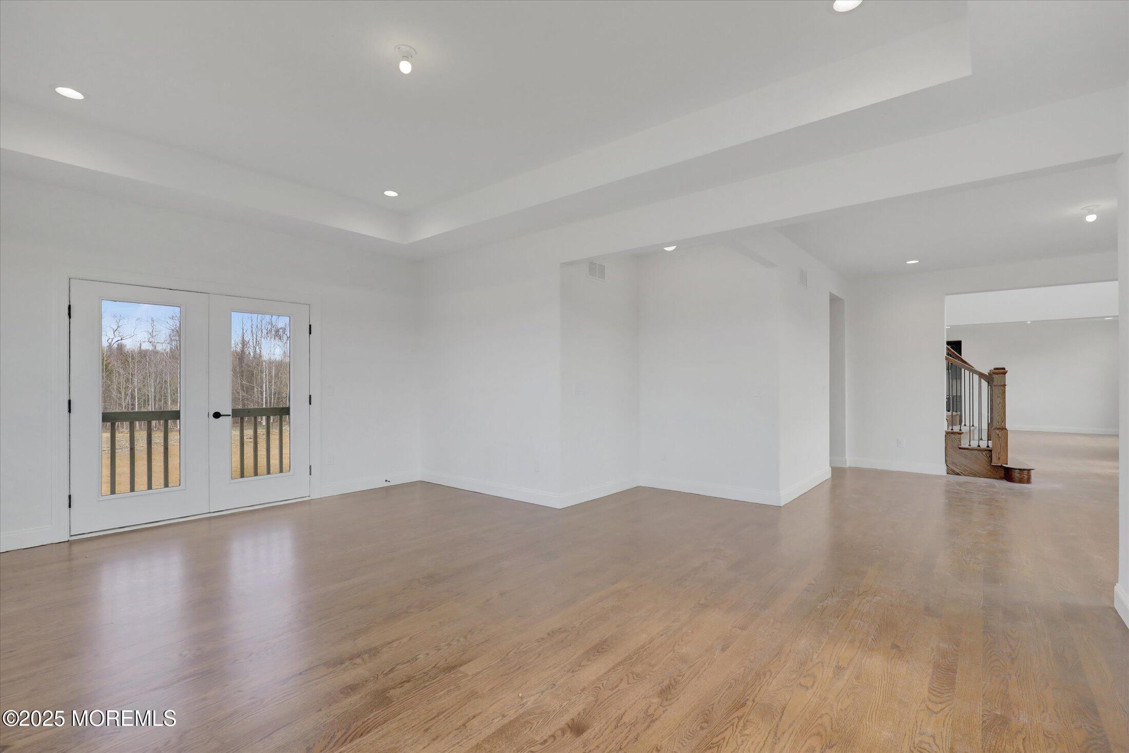 11 Cook Court Millstone Township, NJ 08535 - Photo 37 of 64 a view of empty room with wooden floor and windows