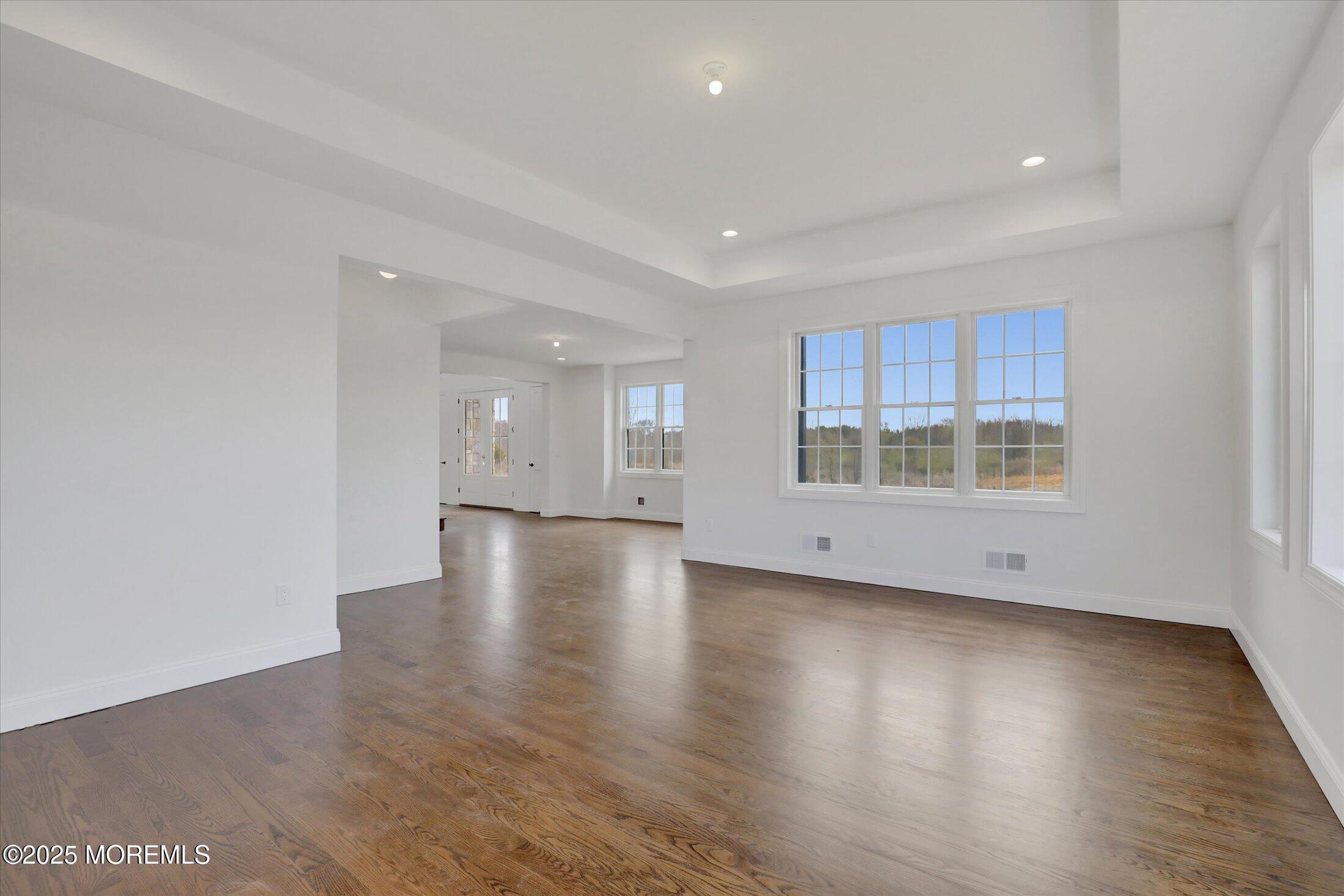 11 Cook Court Millstone Township, NJ 08535 - Photo 38 of 64 a view of an empty room with wooden floor and a window