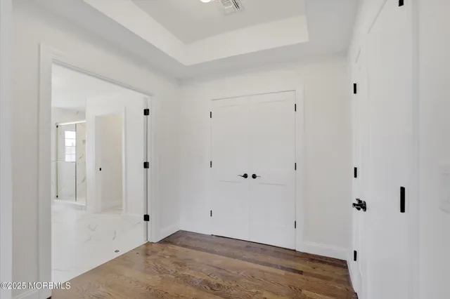 a view of a small space with wooden floor and a window