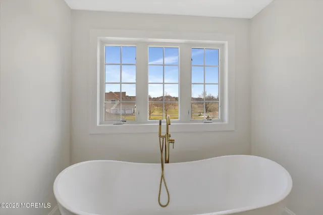 a bathroom with a granite countertop toilet sink and mirror