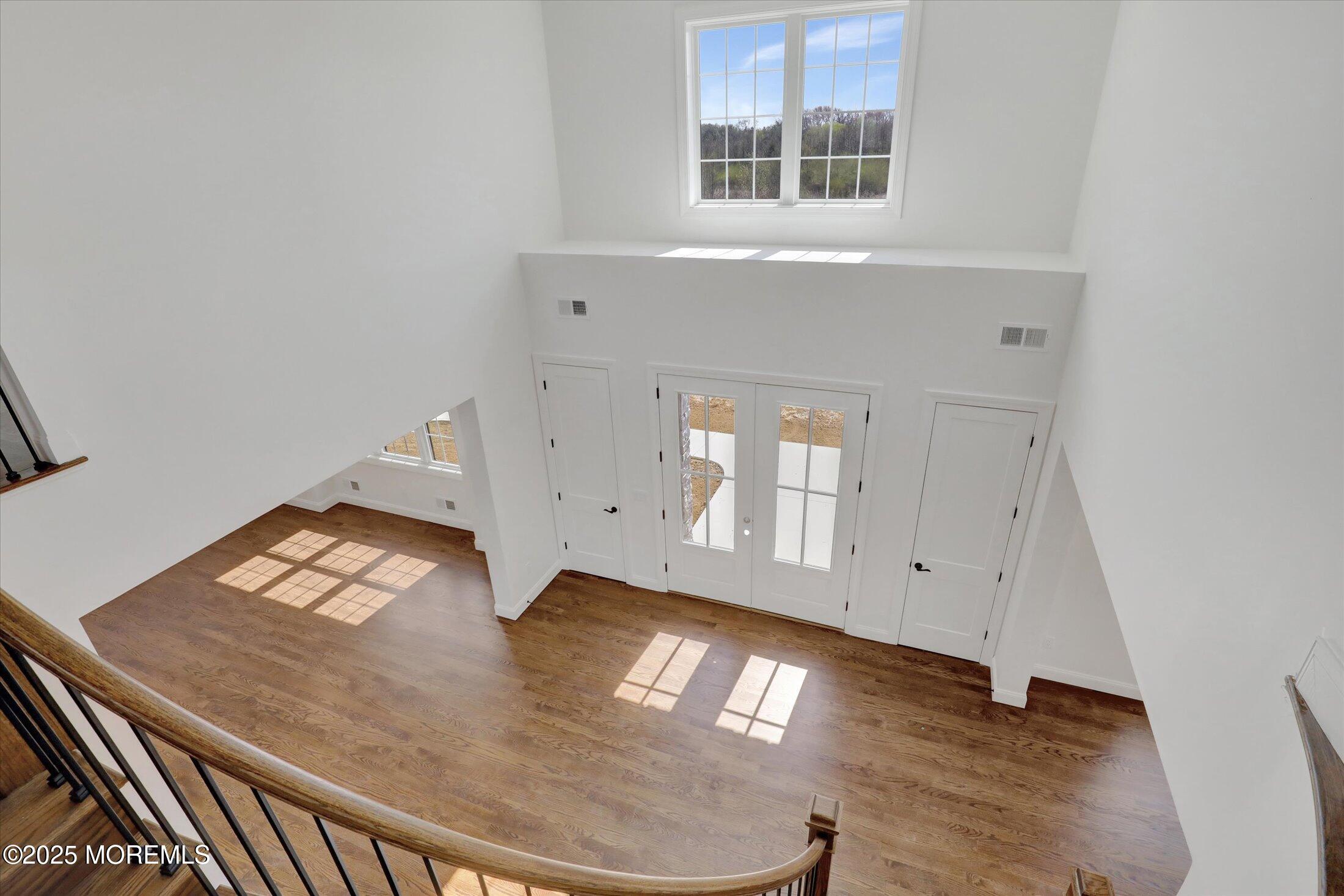 11 Cook Court Millstone Township, NJ 08535 - Photo 46 of 64 a view of an empty room with window and wooden floor