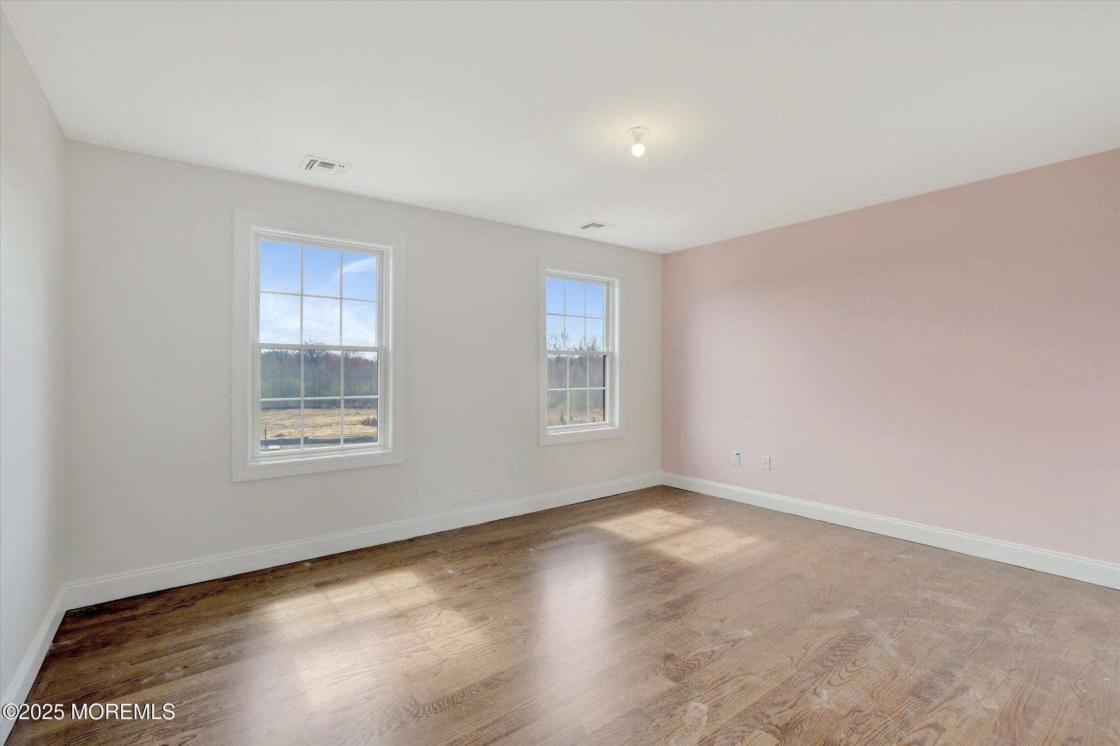 11 Cook Court Millstone Township, NJ 08535 - Photo 58 of 64 a view of an empty room with wooden floor and a window