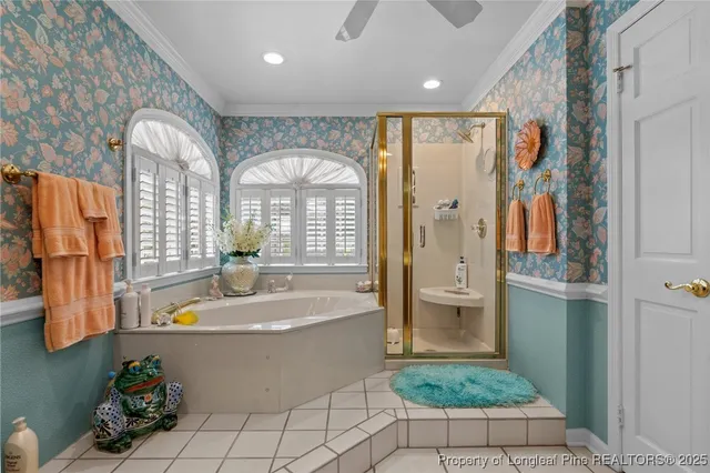 a bathroom with a tub a sink and a shower