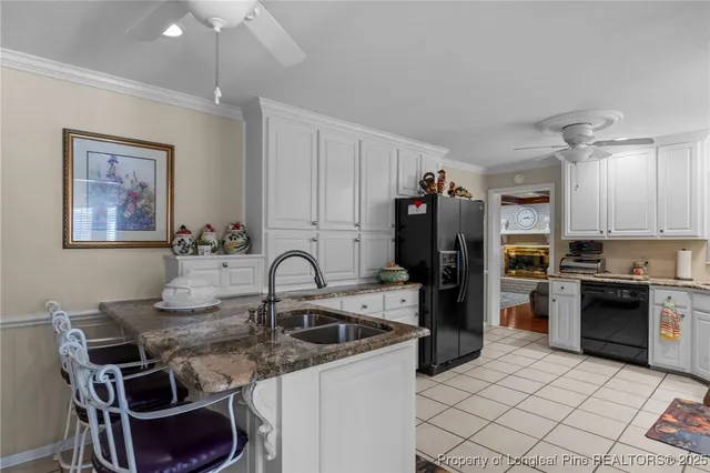 a kitchen with a sink cabinets and stainless steel appliances