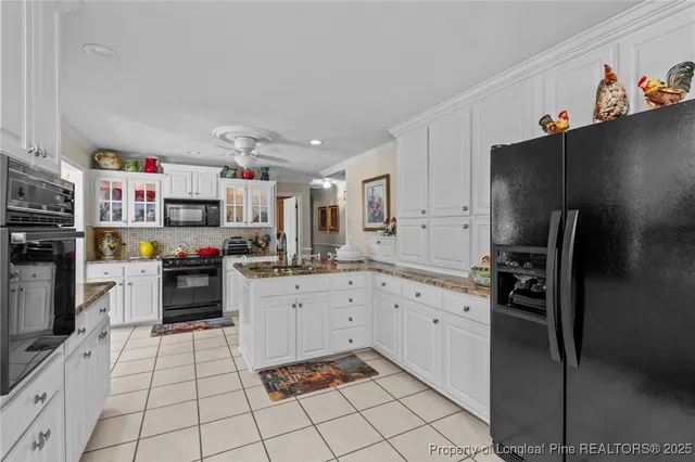 a kitchen with white cabinets and appliances
